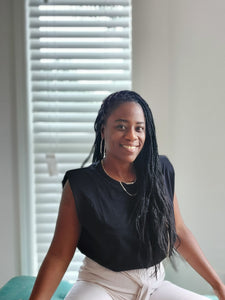 women wearing black sleeveless top with shoulder pads