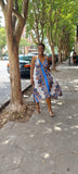 Woman wearing a halter dress with blue and yellow Paisley details