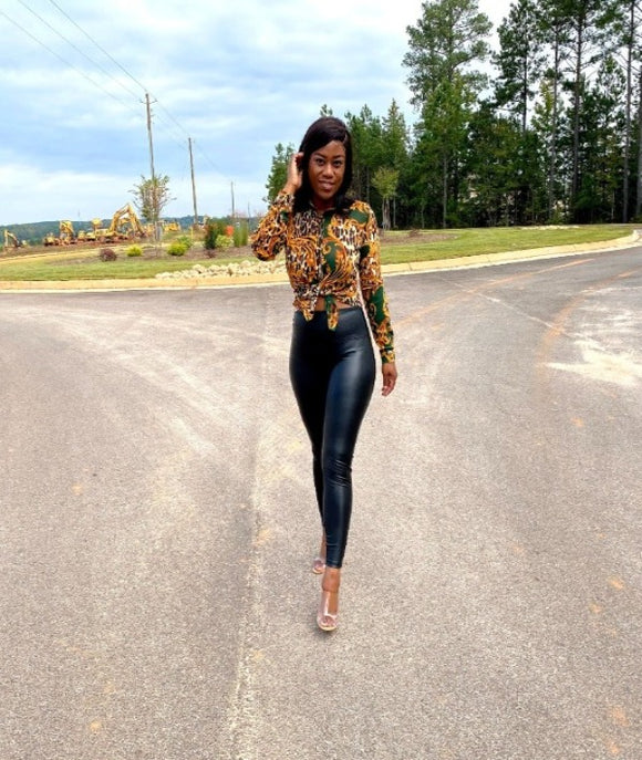 woman wearing green mesh long sleeve animal print top with gold leaf print